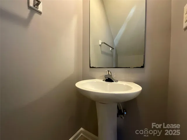 a bathroom with a sink a mirror and a toilet