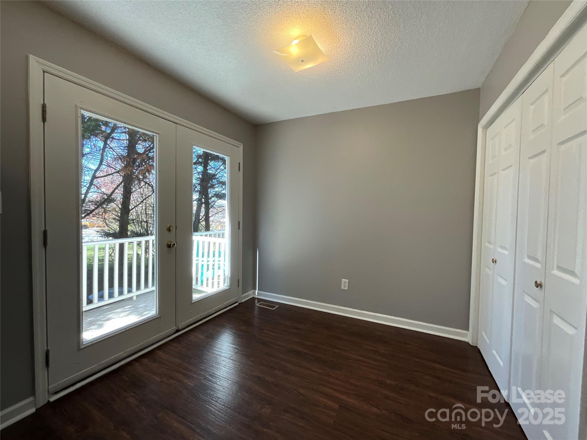 206 West 15th Street, Unit 2 Newton, NC 28658 - Photo 6 of 14 a view of an empty room with wooden floor and a window