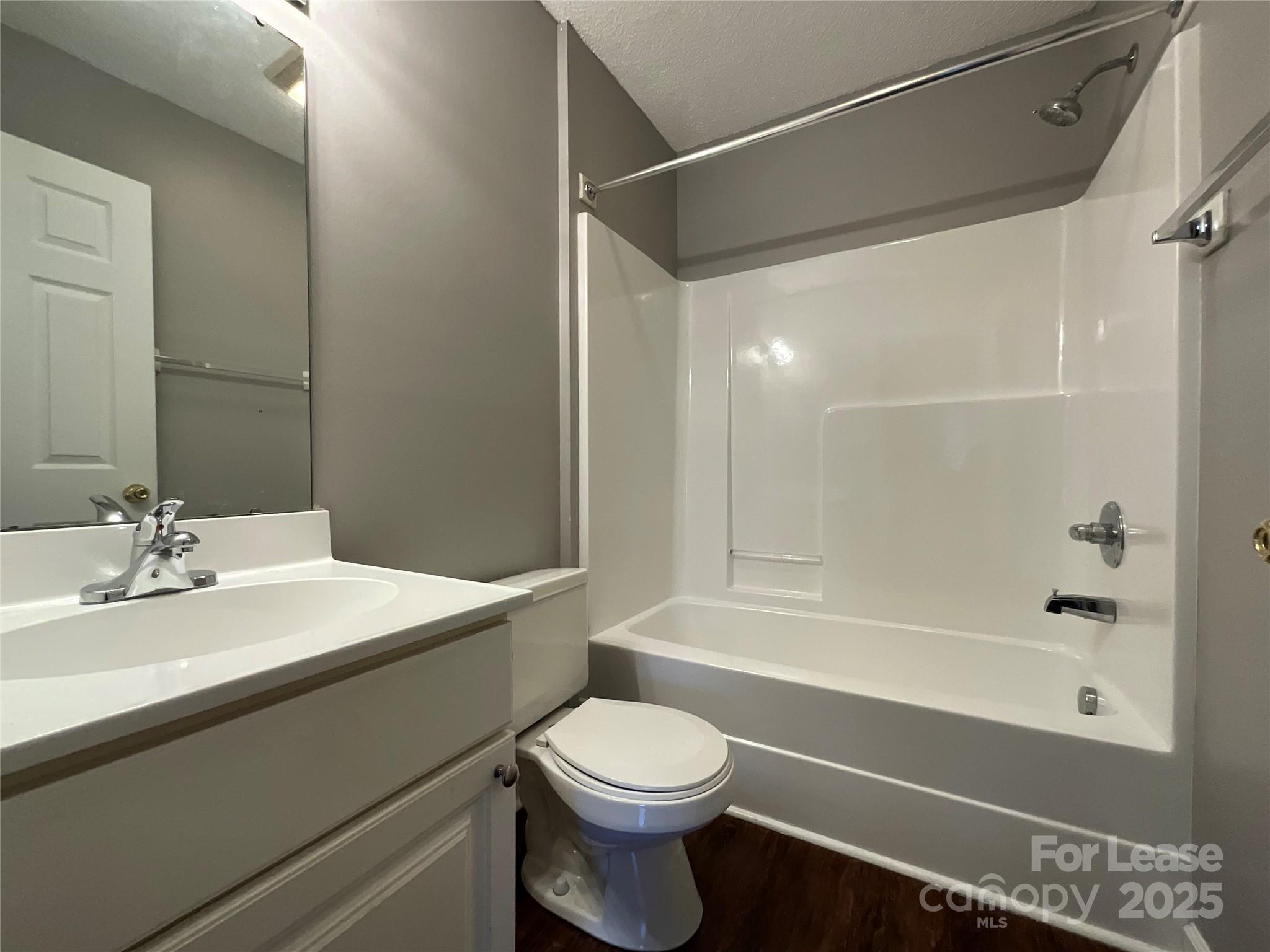 206 West 15th Street, Unit 2 Newton, NC 28658 - Photo 8 of 14 a bathroom with a sink a toilet and a bathtub