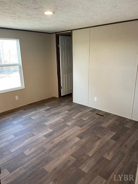 470 Central Church Road Appomattox, VA 24522 - Photo 9 of 12 an empty room with wooden floor and windows with curtains