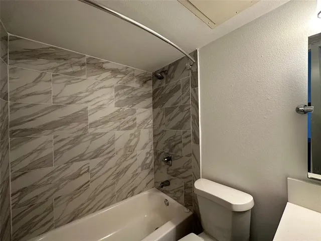 a bathroom with a shower and a toilet