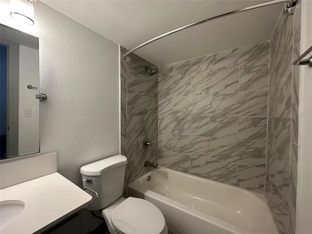 a bathroom with a toilet and a bathtub