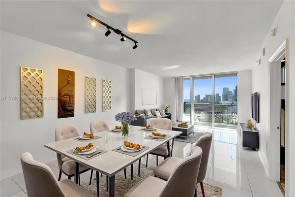 a dining room with furniture a rug and a large window