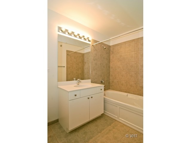 235 West Van Buren Street, Unit 3520 Chicago, IL 60607 - Photo 12 of 17 a bathroom with a sink a toilet and shower