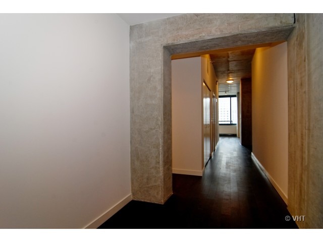 235 West Van Buren Street, Unit 3520 Chicago, IL 60607 - Photo 13 of 17 a view of a hallway with wooden floor