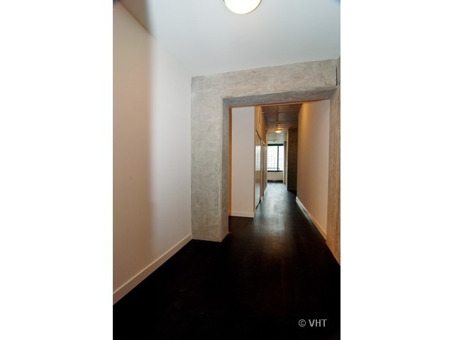 235 West Van Buren Street, Unit 3520 Chicago, IL 60607 - Photo 14 of 17 a view of a hallway with wooden floor and stairs