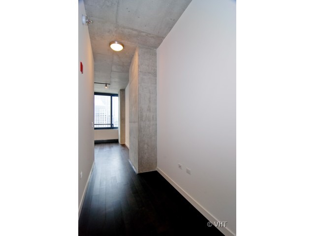 235 West Van Buren Street, Unit 3520 Chicago, IL 60607 - Photo 15 of 17 a view of a room with wooden floor