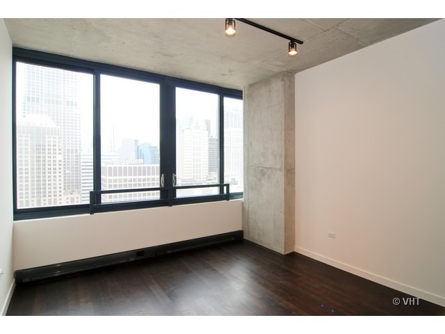 235 West Van Buren Street, Unit 3520 Chicago, IL 60607 - Photo 2 of 17 a view of an empty room with a window