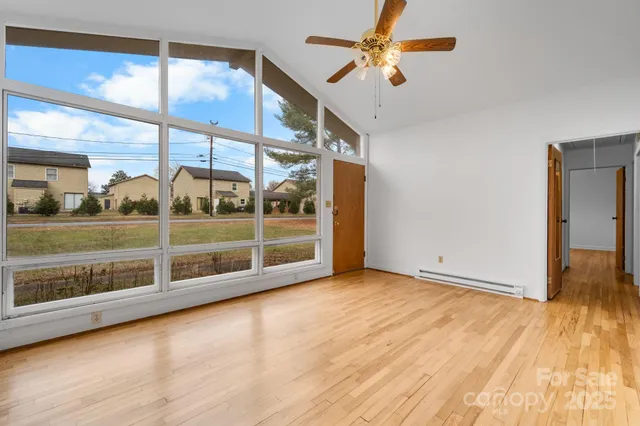 an empty room with a empty space and a ceiling fan