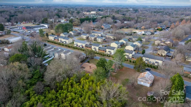 an aerial view of a house with a yard and garden