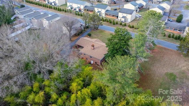 an aerial view of a house with garden space and street view