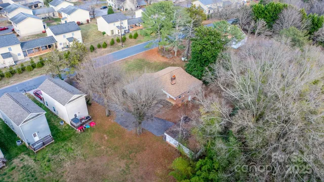 an aerial view of a house with garden space and street view
