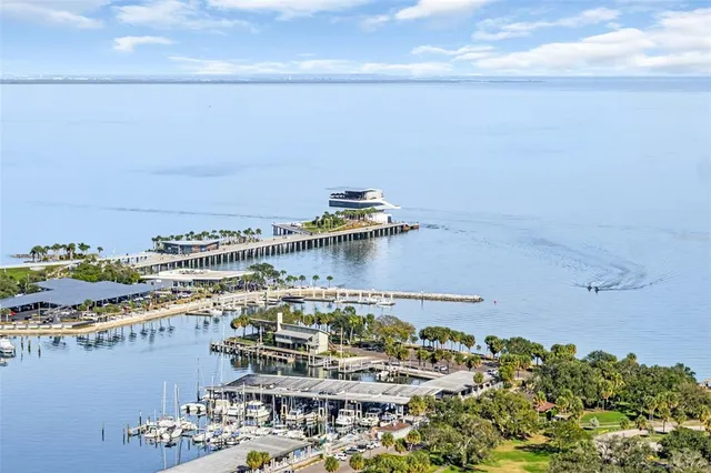 a kitchen with stainless steel appliances granite countertop a sink and white cabinets