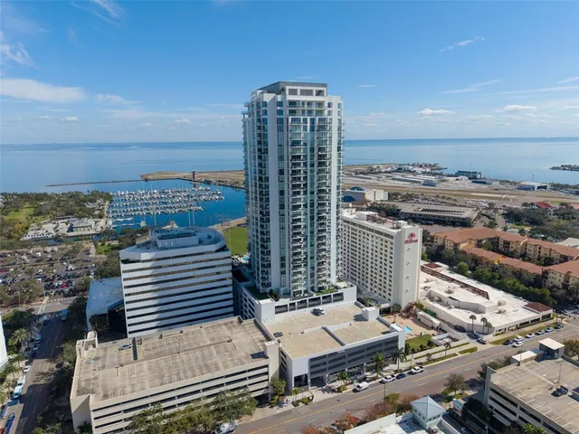a kitchen with stainless steel appliances a stove a sink a microwave and cabinets