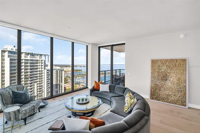 a living room with furniture and a potted plant