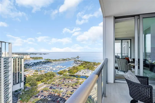 a bedroom with a large bed and a large window