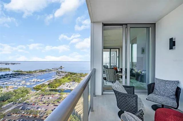 a bedroom with a large bed and a large window