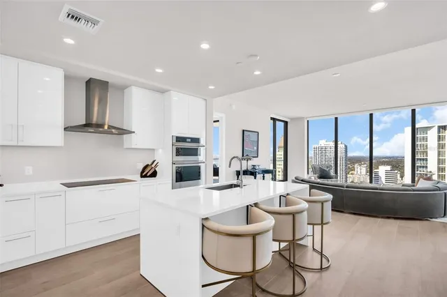 a kitchen with a refrigerator and white cabinets
