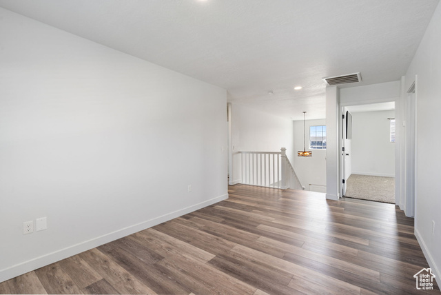 3456 South Linden Way Syracuse, UT 84075 - Photo 17 of 50 Empty room with wood finished floors, baseboards, and recessed lighting