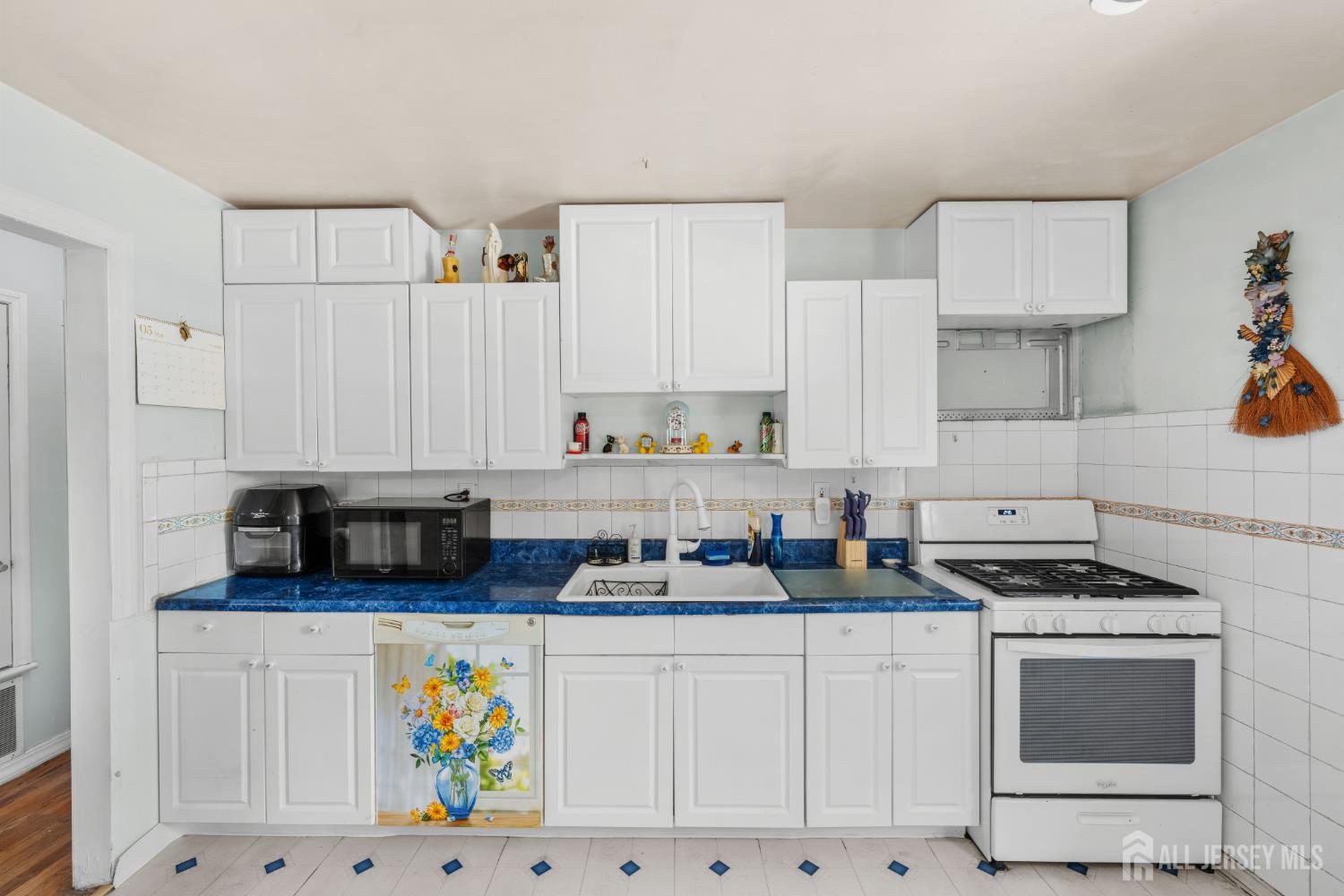 245 4th Street Dunellen, NJ 08812 - Photo 8 of 27 a kitchen with stainless steel appliances a stove a microwave a refrigerator and cabinets