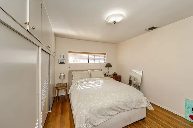 a bedroom with a bed and a mirror