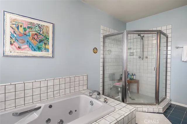 a bathroom with a bathtub and shower