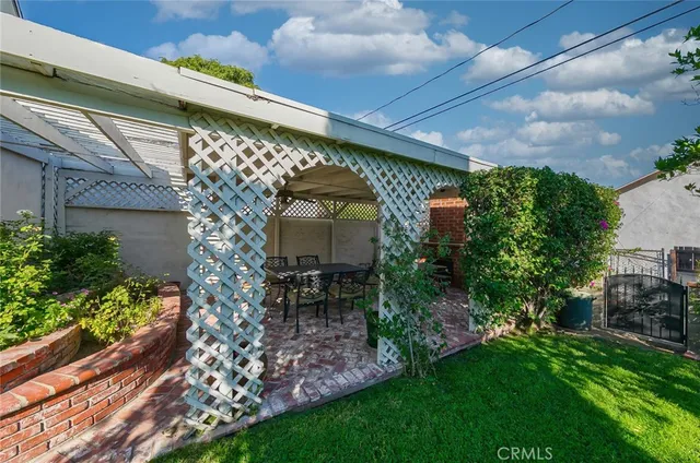 a view of a chair and table in backyard of the house