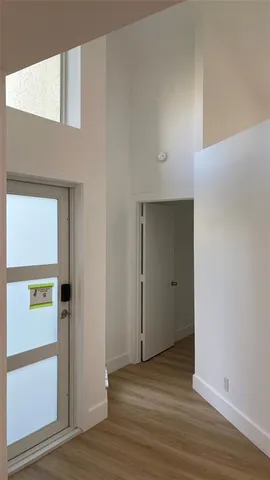 a view of an entryway with wooden floor