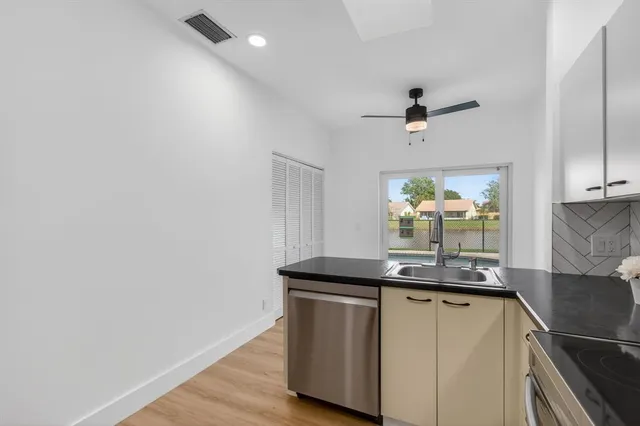 a kitchen with stainless steel appliances a refrigerator and a stove top oven