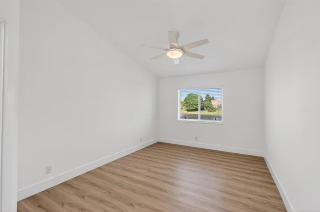 a bedroom with a bed a couch and a flat screen tv