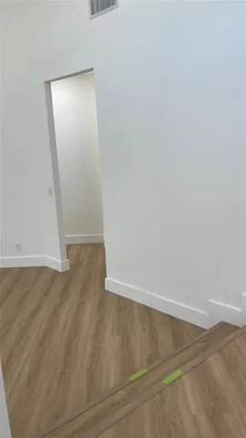 an empty room with wooden floor