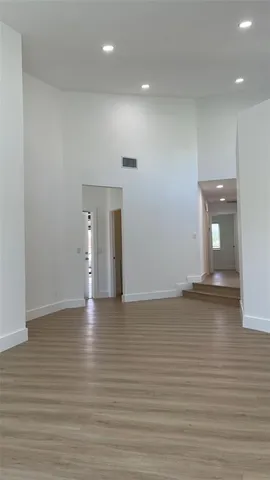 a view of room and window with wooden floor