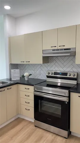 a stove top oven sitting inside of a kitchen