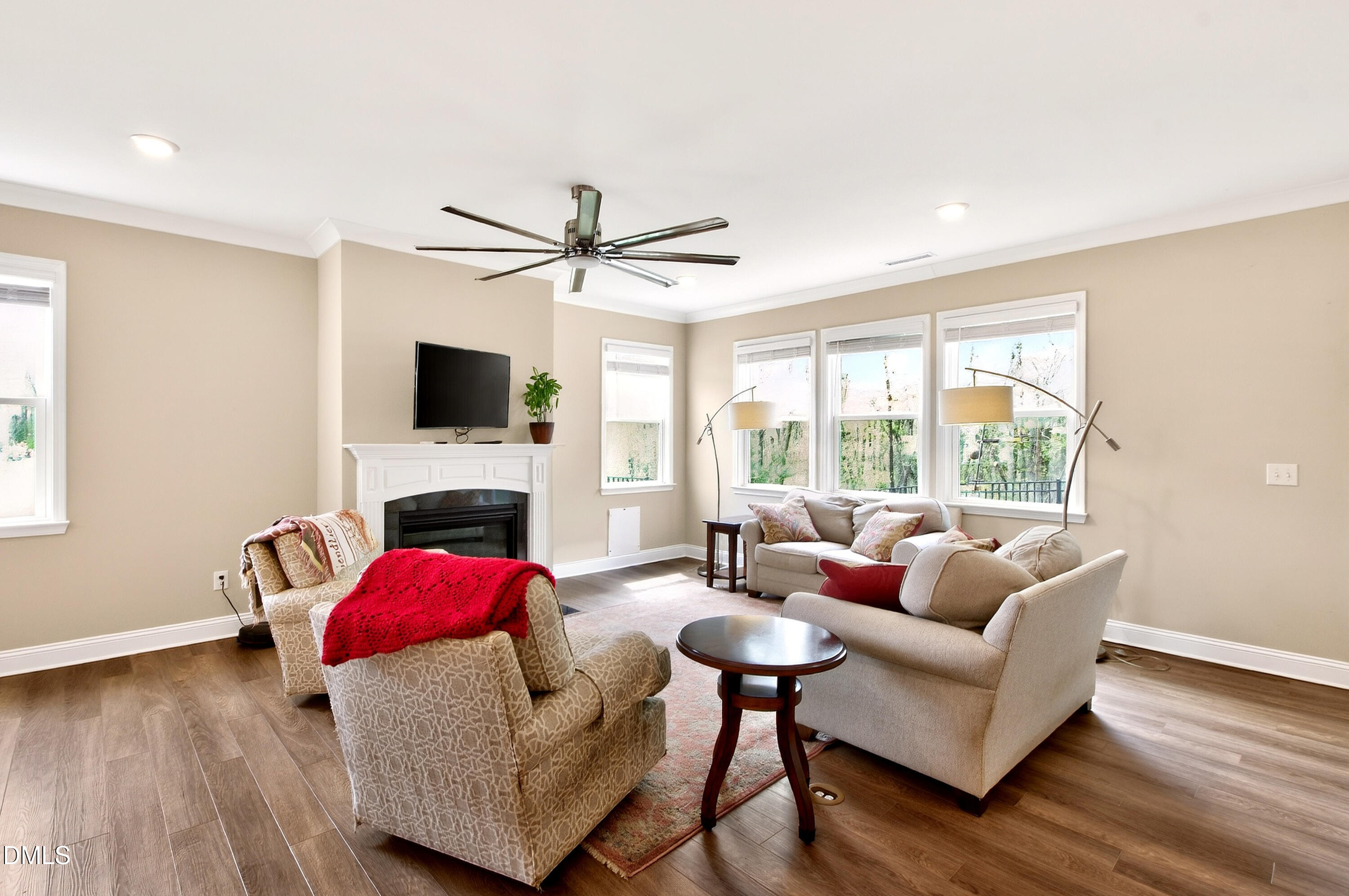 339 Summer Ranch Drive Fuquay-Varina, NC 27526 - Photo 10 of 42 a living room with furniture a fireplace and a flat screen tv