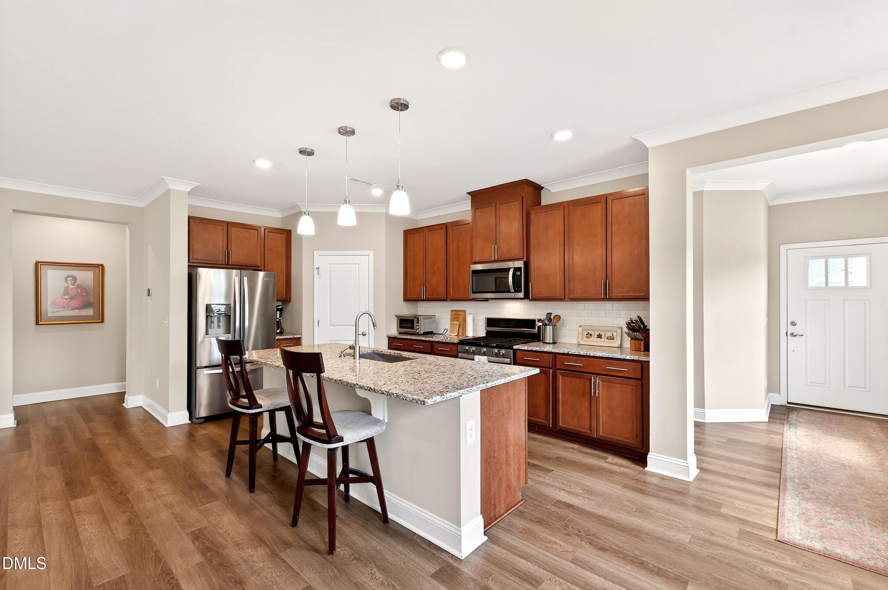 339 Summer Ranch Drive Fuquay-Varina, NC 27526 - Photo 14 of 42 a kitchen with stainless steel appliances granite countertop wooden floors and stove top oven