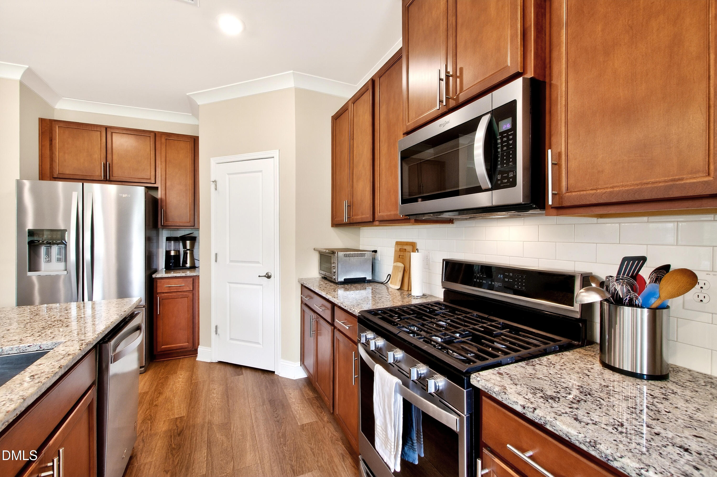 339 Summer Ranch Drive Fuquay-Varina, NC 27526 - Photo 16 of 42 a kitchen with stainless steel appliances granite countertop a stove microwave refrigerator and sink