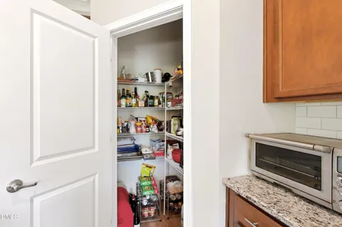 a kitchen with a refrigerator and a stove top oven