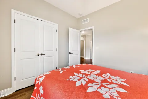 a bedroom with a bed and a dresser