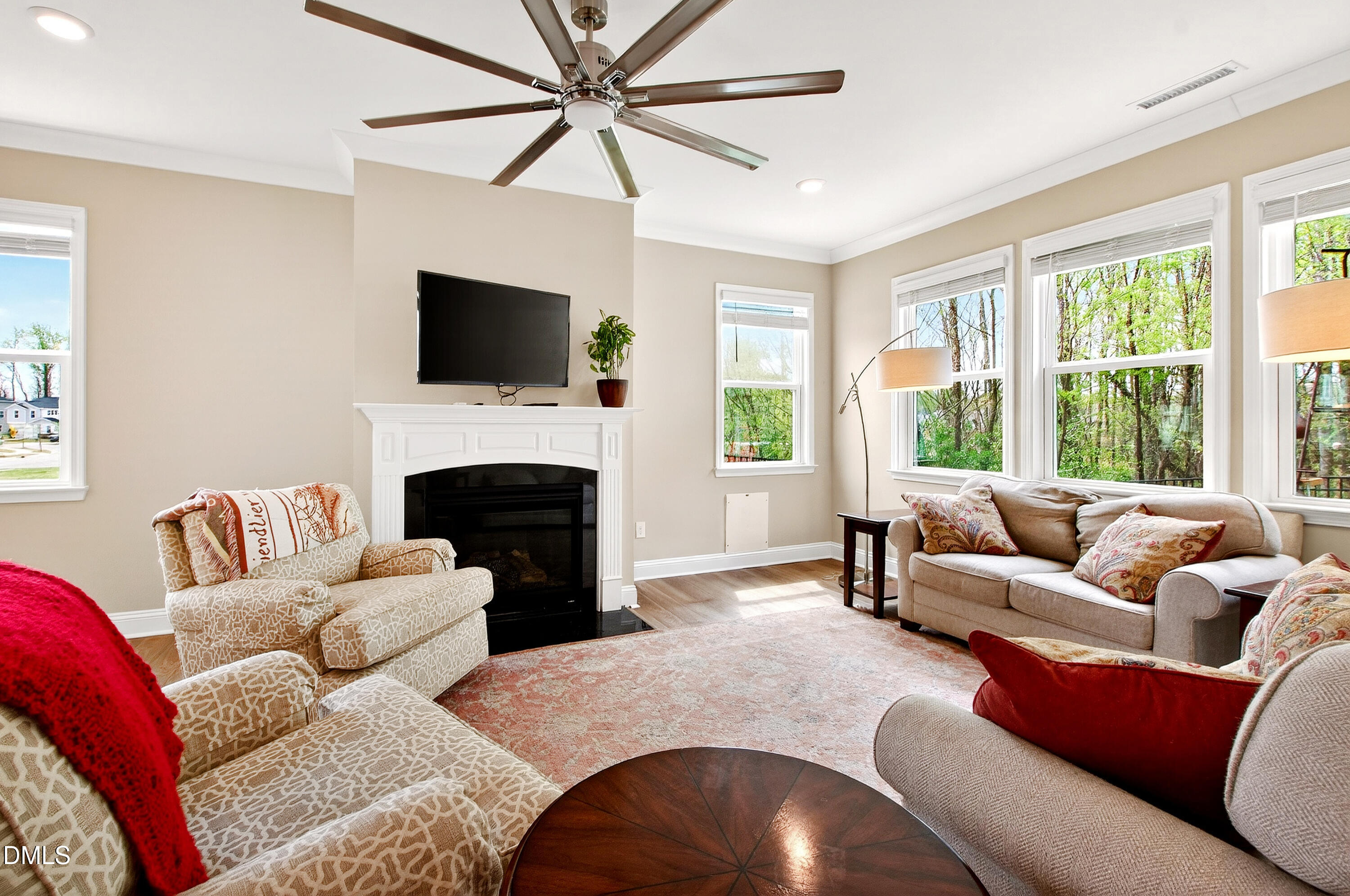 339 Summer Ranch Drive Fuquay-Varina, NC 27526 - Photo 2 of 42 a living room with furniture a flat screen tv and a fireplace