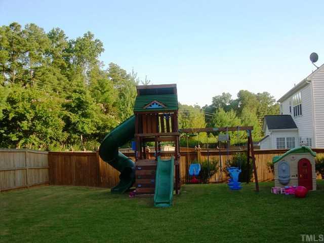7620 Silver View Lane Raleigh, NC 27613 - Photo 11 of 12 a view of an house with backyard space and deck