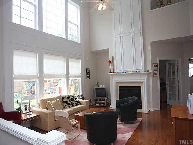7620 Silver View Lane Raleigh, NC 27613 - Photo 2 of 12 a living room with furniture large window and a fireplace