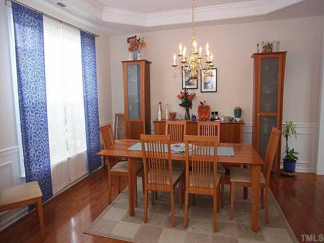 7620 Silver View Lane Raleigh, NC 27613 - Photo 3 of 12 a view of a dining room with furniture window and wooden floor