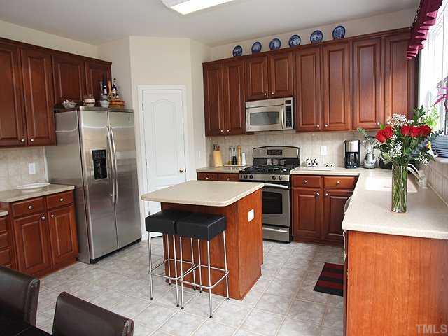 7620 Silver View Lane Raleigh, NC 27613 - Photo 4 of 12 a kitchen with stainless steel appliances granite countertop a refrigerator a stove a sink dishwasher and microwave