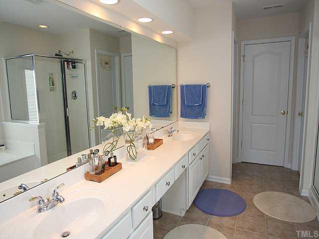 7620 Silver View Lane Raleigh, NC 27613 - Photo 7 of 12 a bathroom with a granite countertop sink toilet and shower