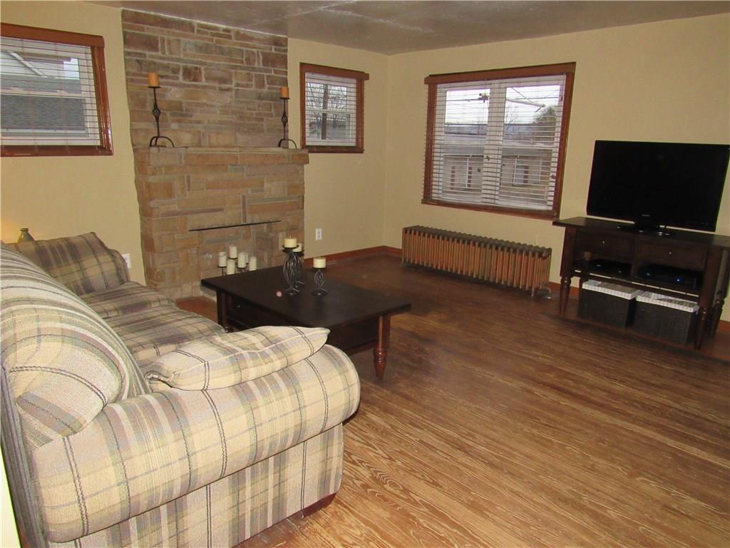 615 Unity Street Latrobe, PA 15650 - Photo 3 of 24 Living room with real hardwood flooring & decorative stone fireplace.