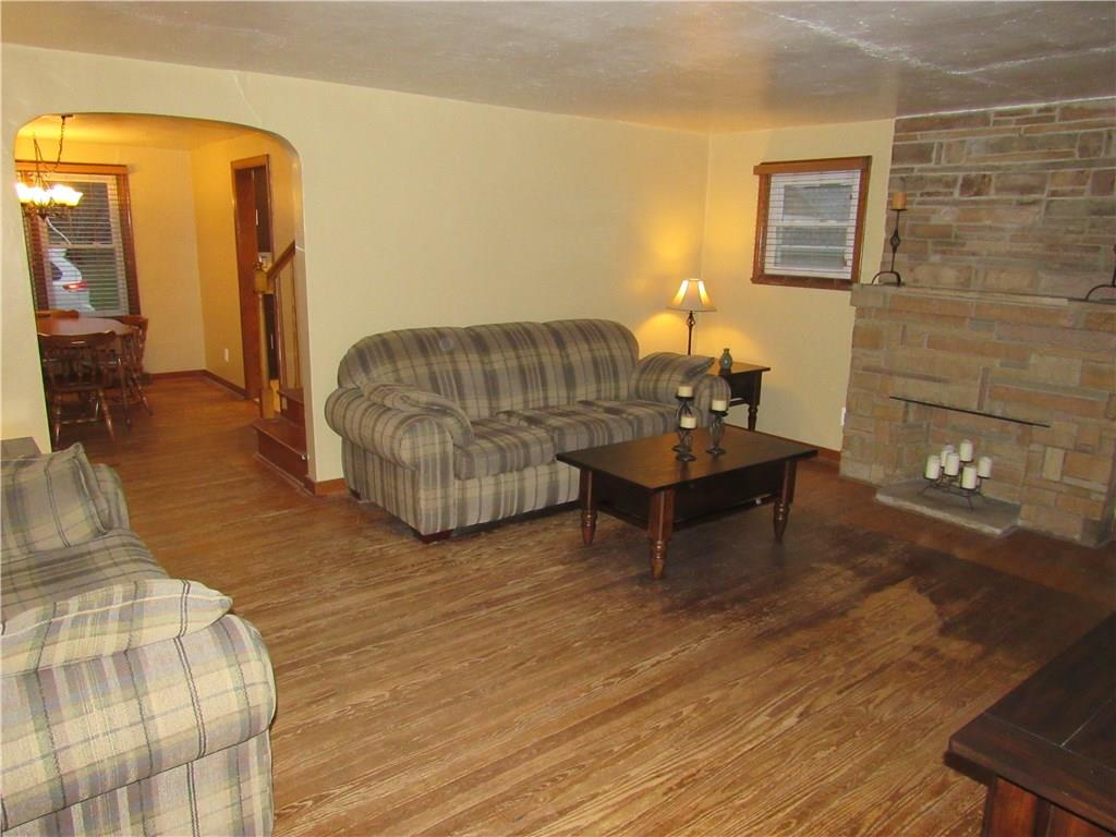 615 Unity Street Latrobe, PA 15650 - Photo 4 of 24 Living room with real hardwood flooring & decorative stone fireplace.