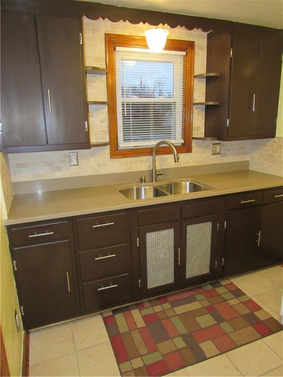 615 Unity Street Latrobe, PA 15650 - Photo 7 of 24 Kitchen with new quartz counter tops with neutral tiled backsplash and floor