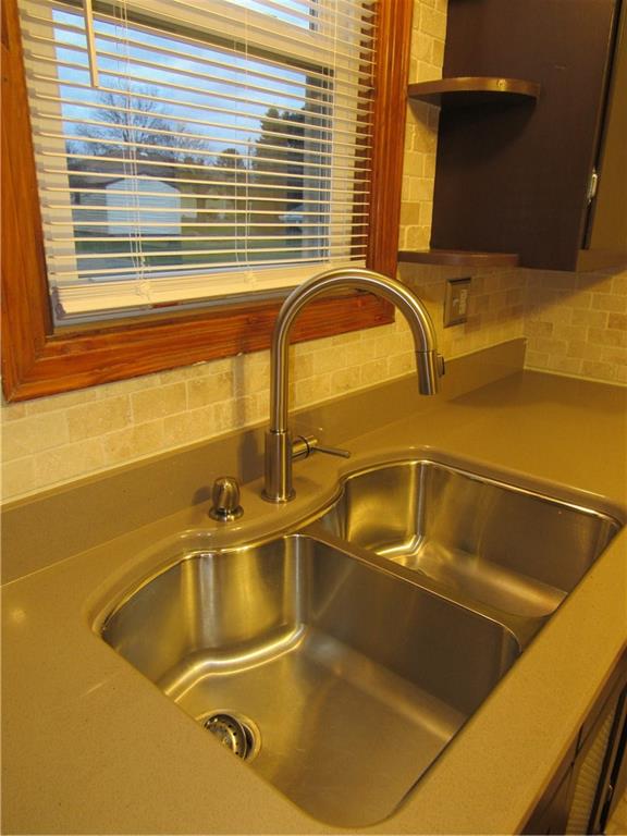 615 Unity Street Latrobe, PA 15650 - Photo 8 of 24 New Quartz counter top with stainless steel double bowl sink. Neutral tiled backsplash