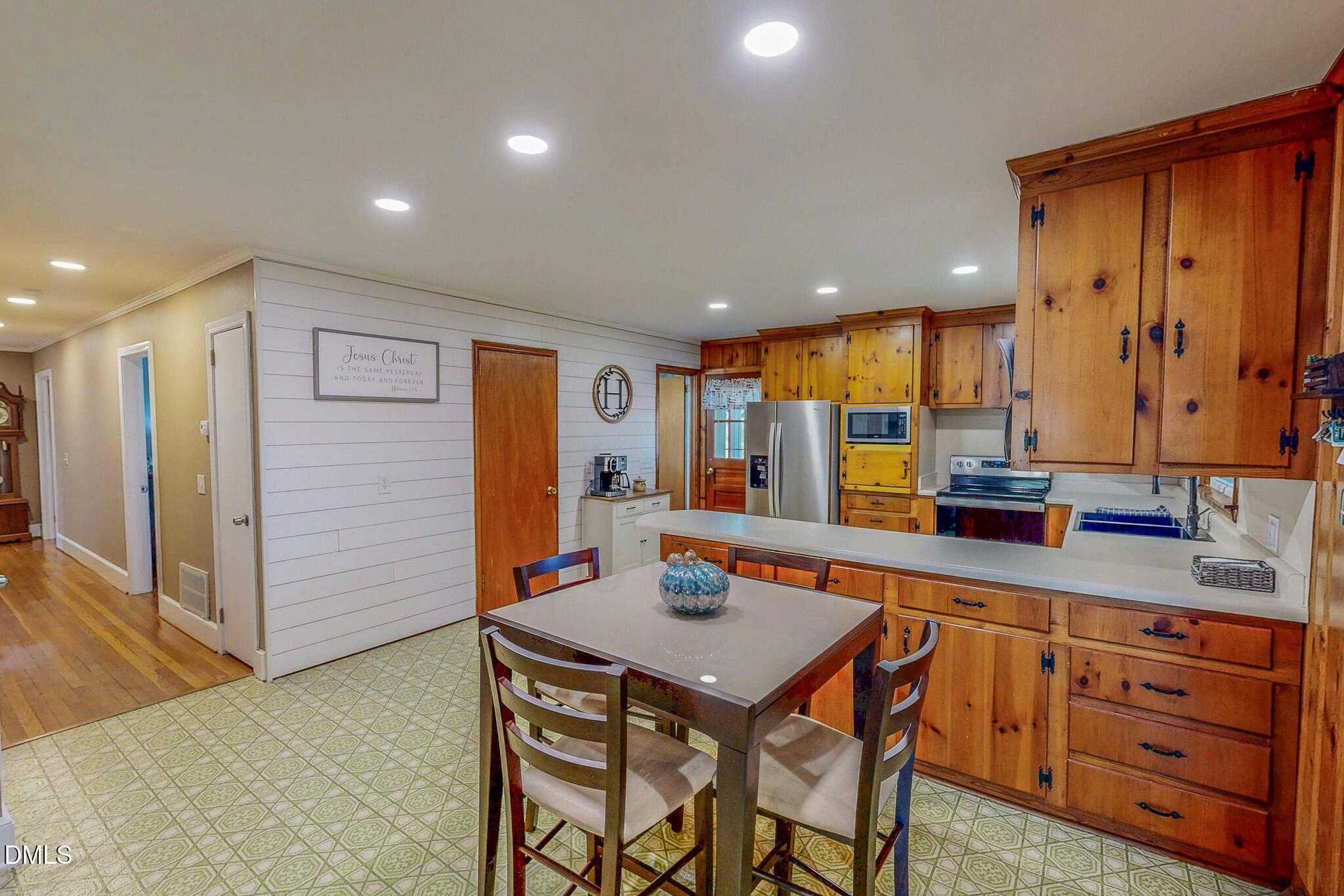 12057 Hurdle Mills Road Hurdle Mills, NC 27541 - Photo 14 of 52 a kitchen with stainless steel appliances granite countertop a sink a stove a dining table and chairs with wooden floor