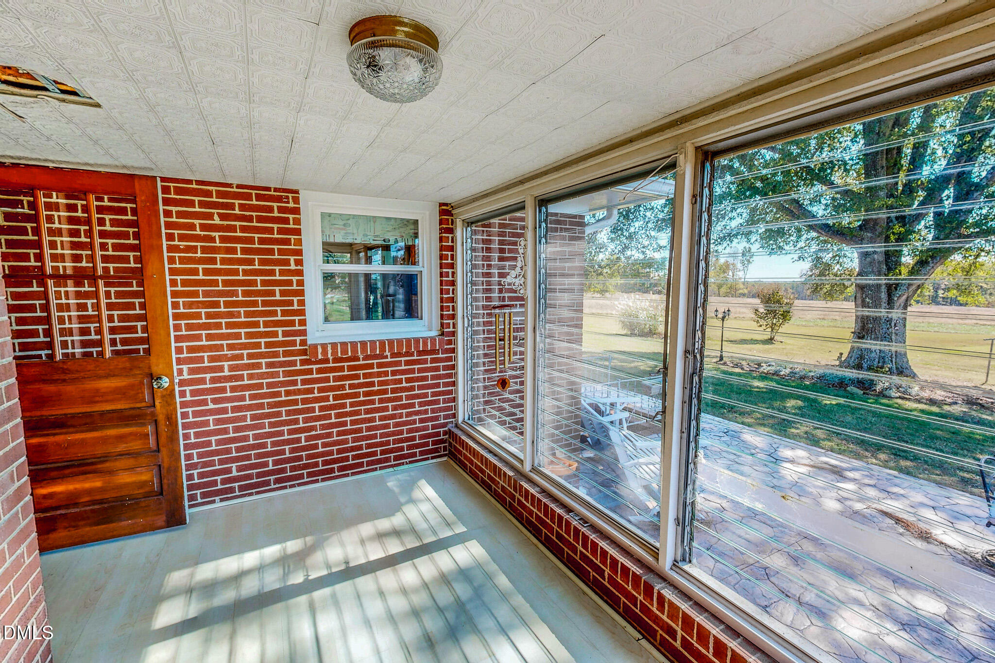 12057 Hurdle Mills Road Hurdle Mills, NC 27541 - Photo 18 of 52 a view of a balcony with floor to ceiling windows with wooden floor